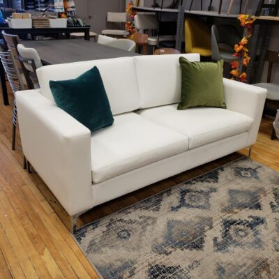 White sofa with square arms and silver metal legs.