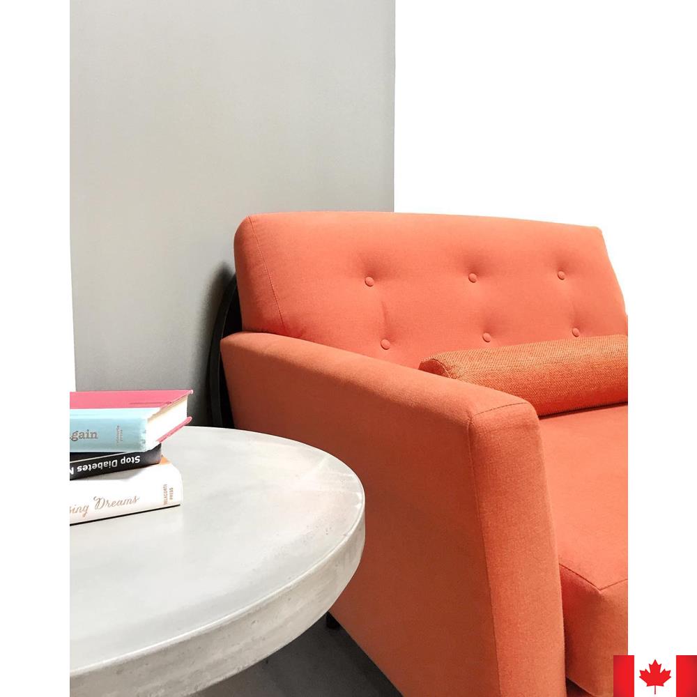 Extra wide orange chair with buttoned back.