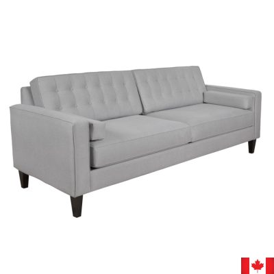 Light grey sofa with boxy shape, and 2 rows of button tufting on loose back cushions.