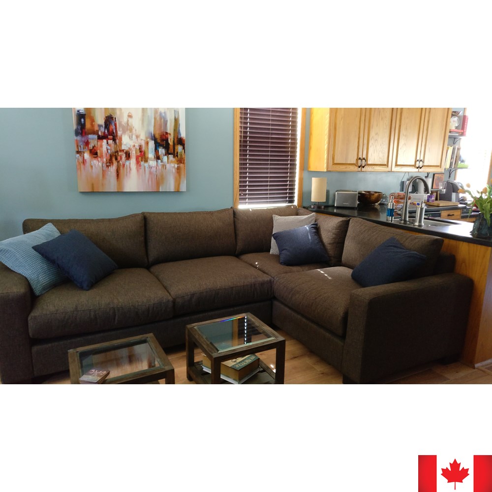 Sectional sofa in dark brown fabric.