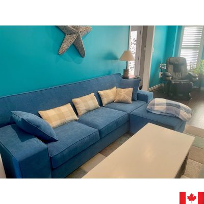 Medium blue sofa with wide boxy arms.