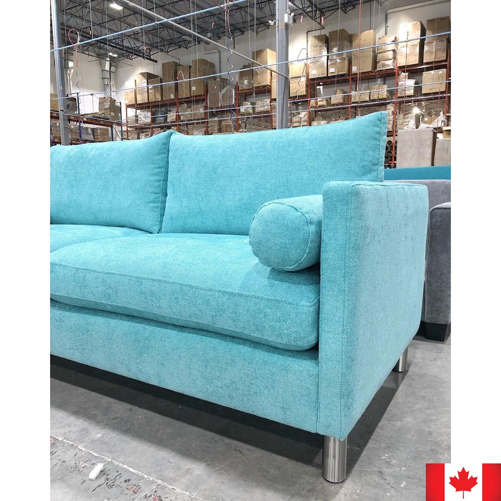 Turquoise sofa with slim arms, and silver metal legs.